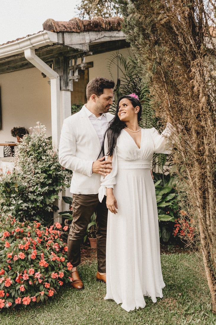 Loving newlywed couple standing in garden